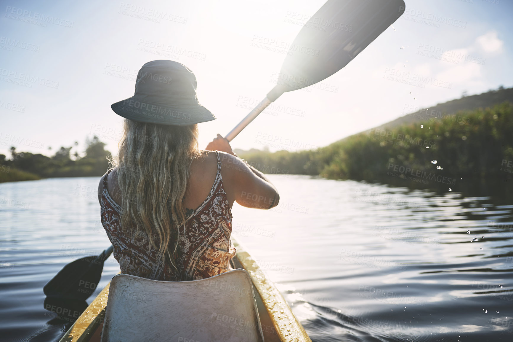 Buy stock photo Shot of a young woman out kayaking on a lake