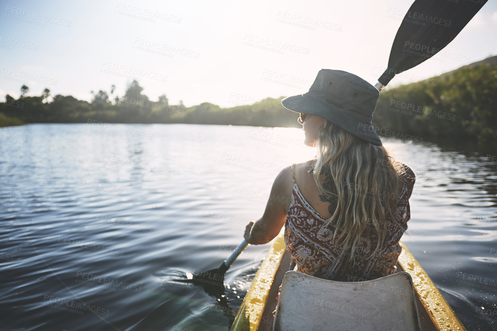 Buy stock photo Shot of a young woman out canoeing on a lake