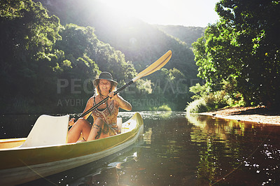 Buy stock photo Shot of a young woman out kayaking on a lake