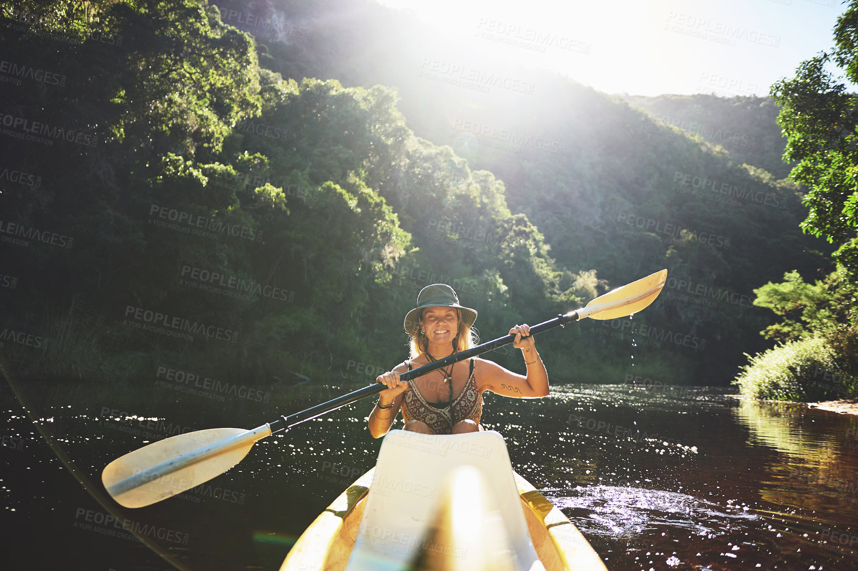 Buy stock photo Shot of a young woman out kayaking on a lake