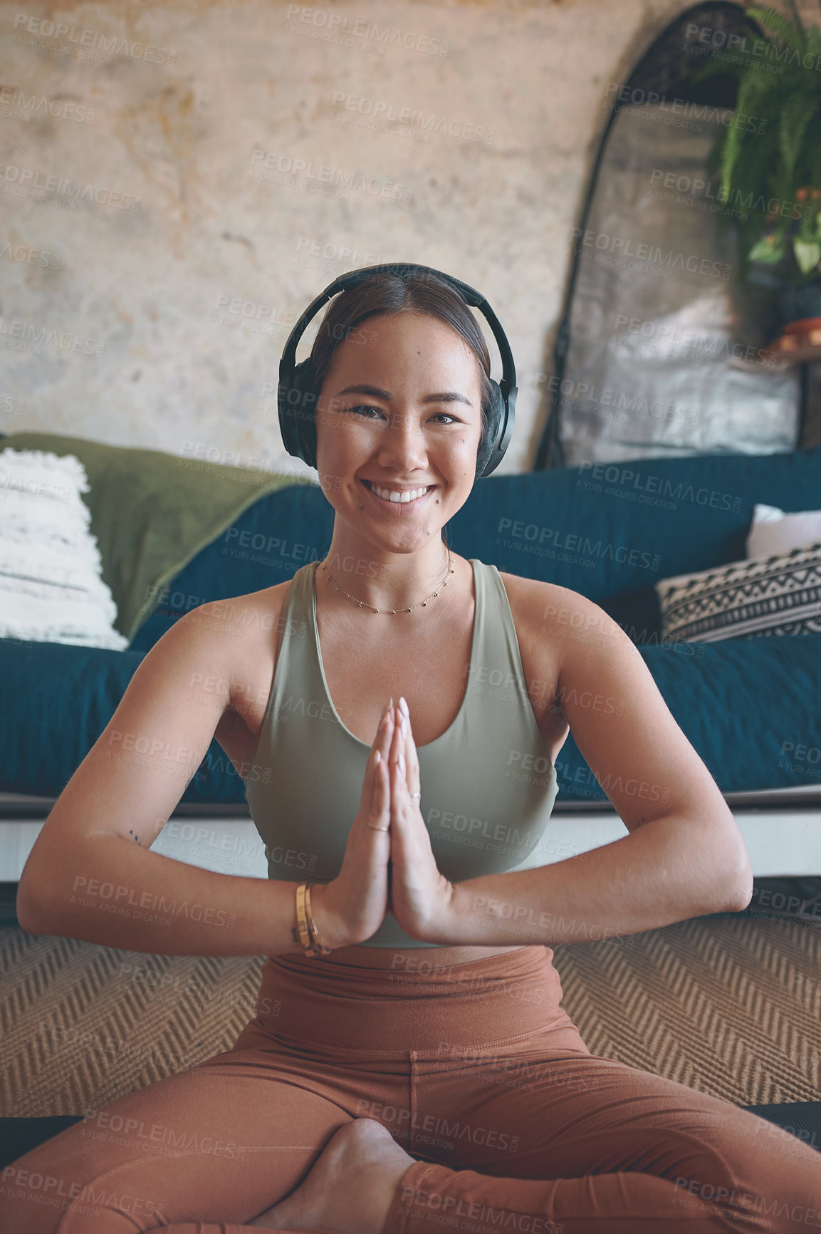 Buy stock photo Portrait of a young woman meditating while practising yoga at home