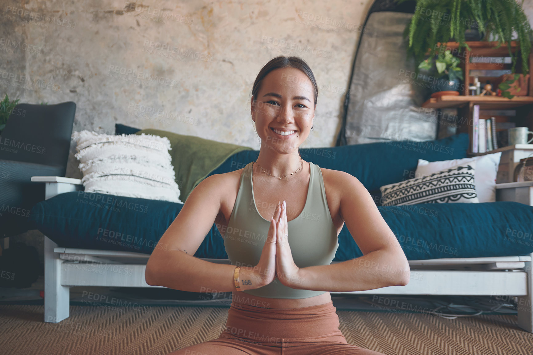 Buy stock photo Portrait of a young woman meditating while practising yoga at home