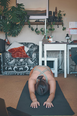 Buy stock photo Shot of a young woman practising yoga at home