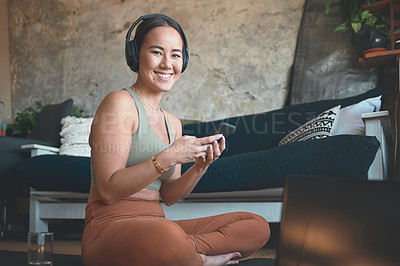 Buy stock photo Portrait of a young woman using a cellphone and laptop while exercising at home