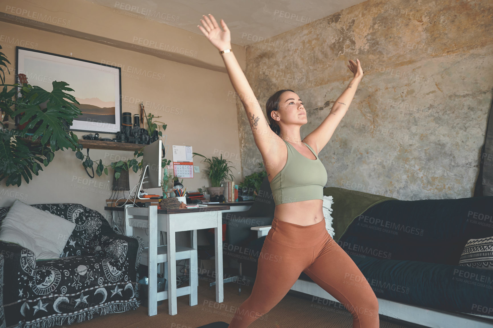 Buy stock photo Shot of a young woman exercising at home