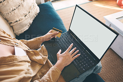 Buy stock photo Shot of an unrecognisable woman using a laptop and credit card on the sofa at home