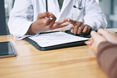 Buy stock photo Cropped shot of an unrecognizable doctor sitting with his patient and explaining her diagnosis during a consultation in the clinic