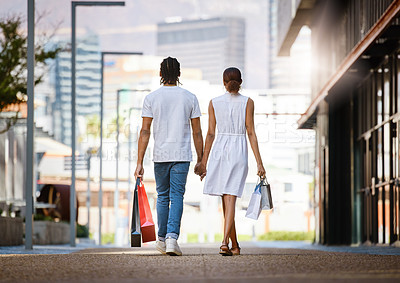 Buy stock photo Couple, shopping and walk holding hands in city with bags from retail, sales and relax on holiday or vacation. Customer, people and travel to mall on date with promo purchase of product or fashion