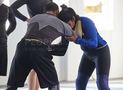 Buy stock photo Cropped shot of a jiu jitsu sensei sparring with one of his students during a class