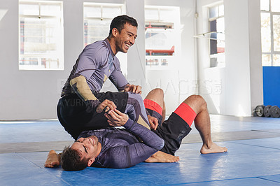 Buy stock photo People laugh together in gym, martial arts and fitness with combat, jiu jitsu and students learning self defense skills. Fight, exercise and MMA with fighting sport and men with fun and train at dojo