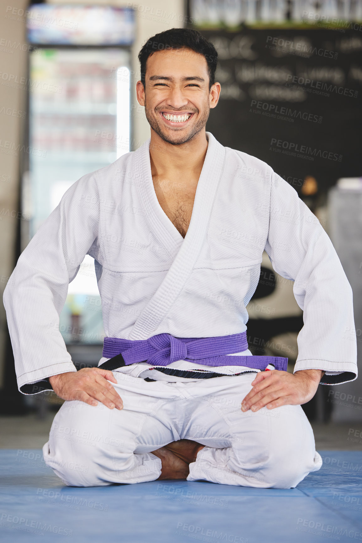 Buy stock photo Full length portrait of a handsome young man kneeling in full jiu jitsu gi in the gym