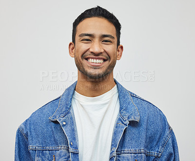 Buy stock photo Cropped portrait of a handsome young man posing in studio against a grey background