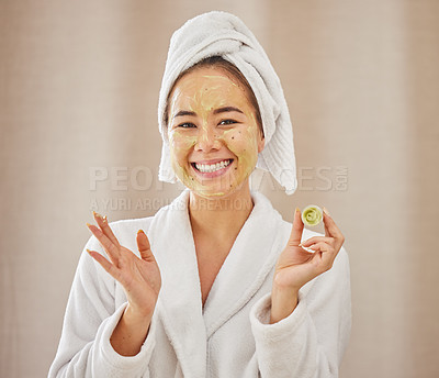 Buy stock photo Shot of a young woman applying a face mask at home