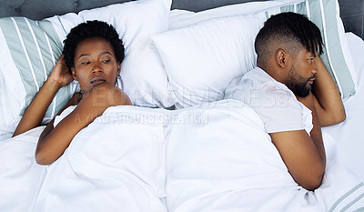 Buy stock photo Shot of a young couple having a disagreement in the bedroom at home