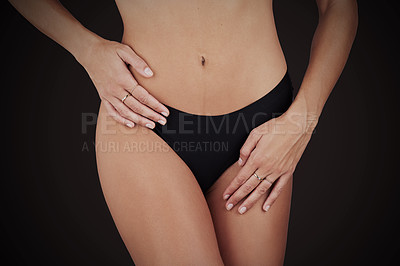 Buy stock photo Cropped shot of an unrecognizable woman posing in black panties against a black background