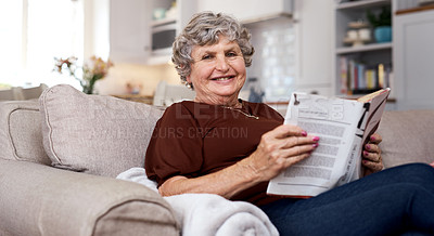 Buy stock photo Portrait of an elderly woman looking relaxed on the sofa while reading at home