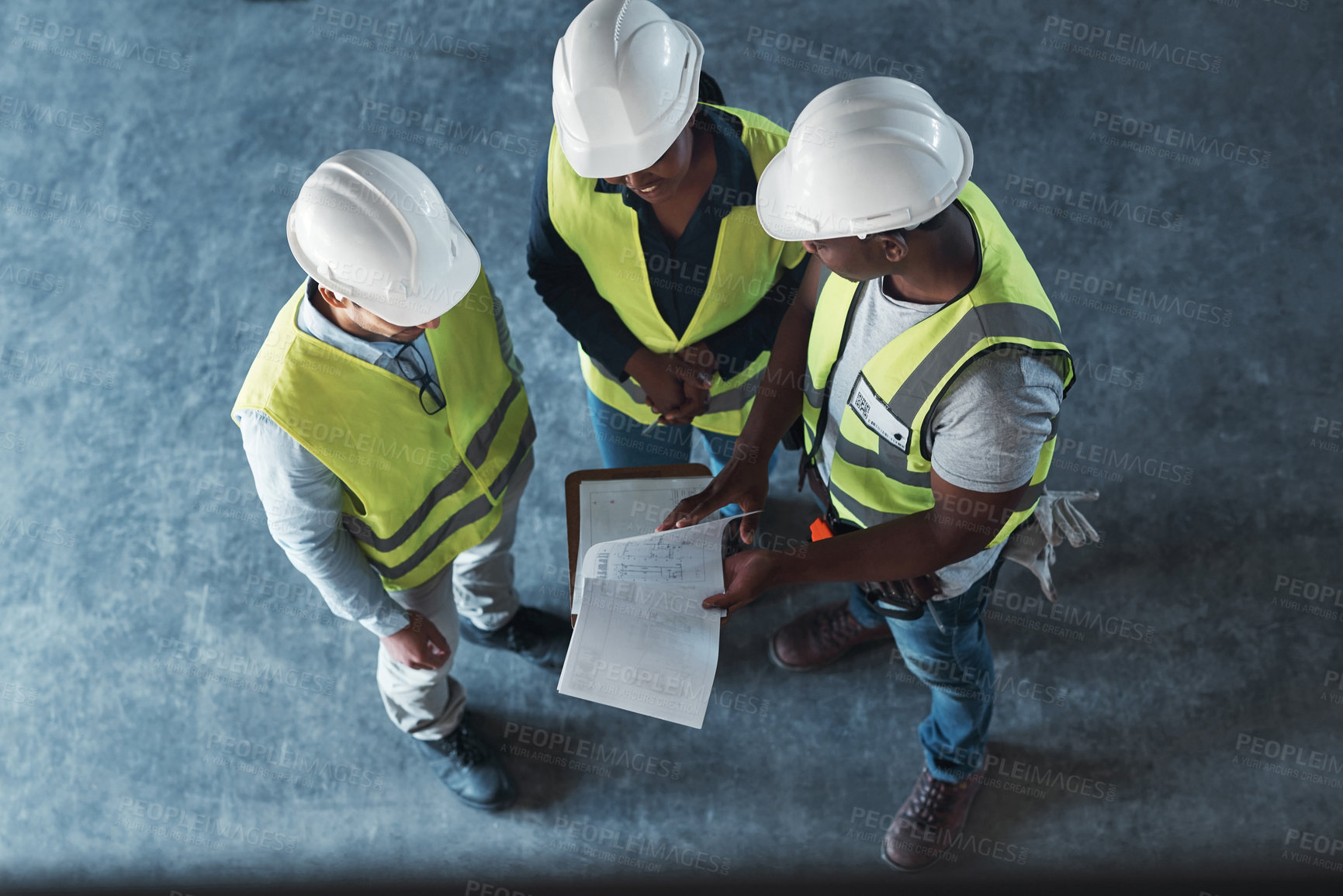 Buy stock photo High angle shot of a group of contractors standing in the warehouse together and having a discussion