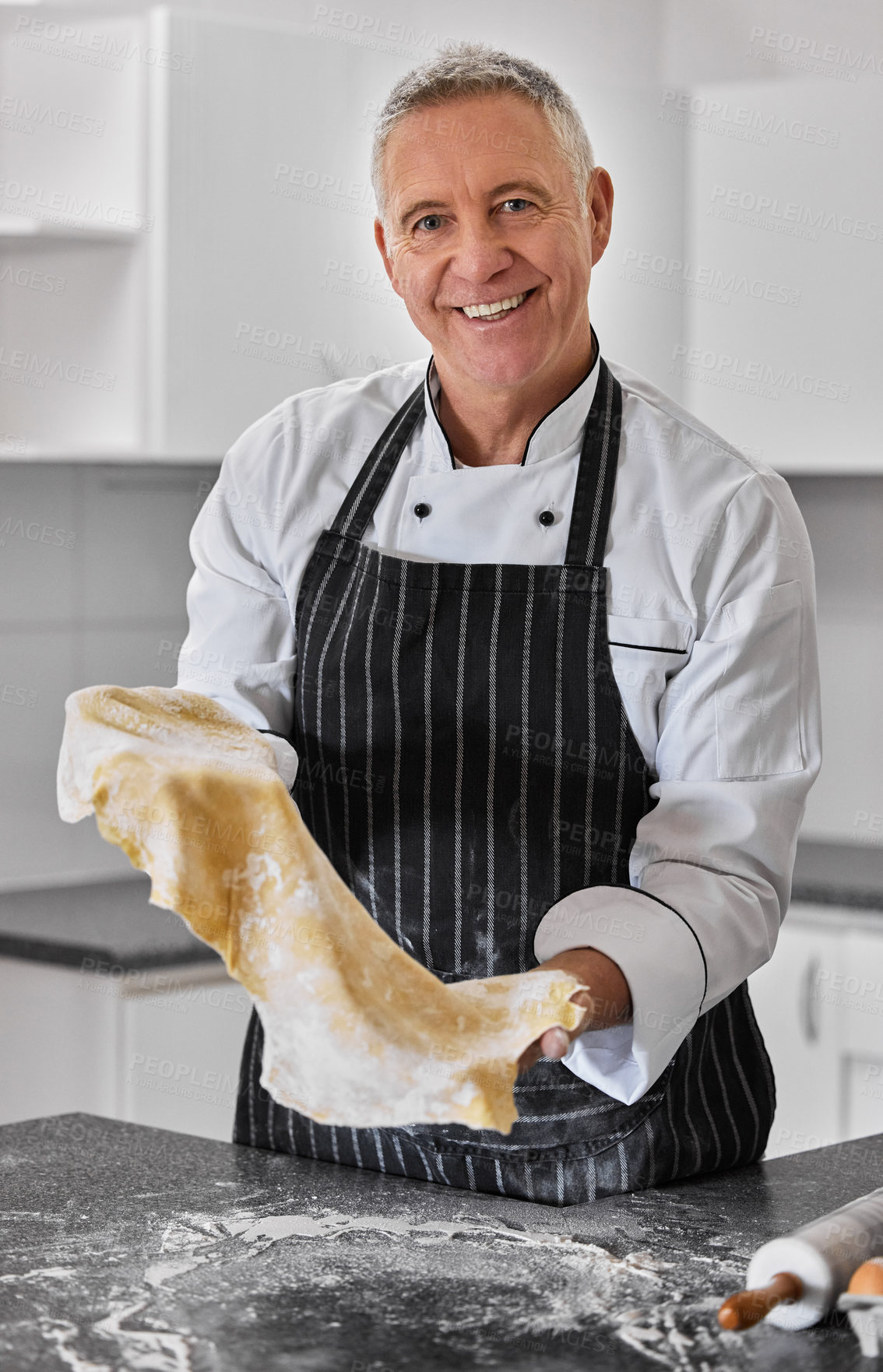 Buy stock photo Portrait of a mature man preparing freshly made pasta