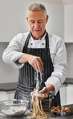 Buy stock photo Shot of a mature man preparing freshly made pasta