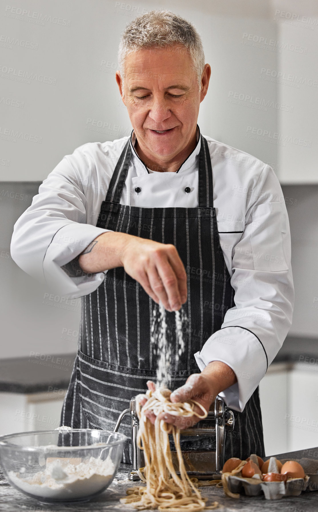 Buy stock photo Shot of a mature man preparing freshly made pasta