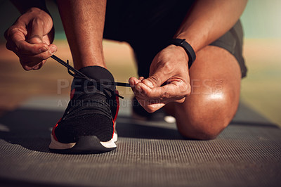 Buy stock photo Shot of a man tying his laces before running