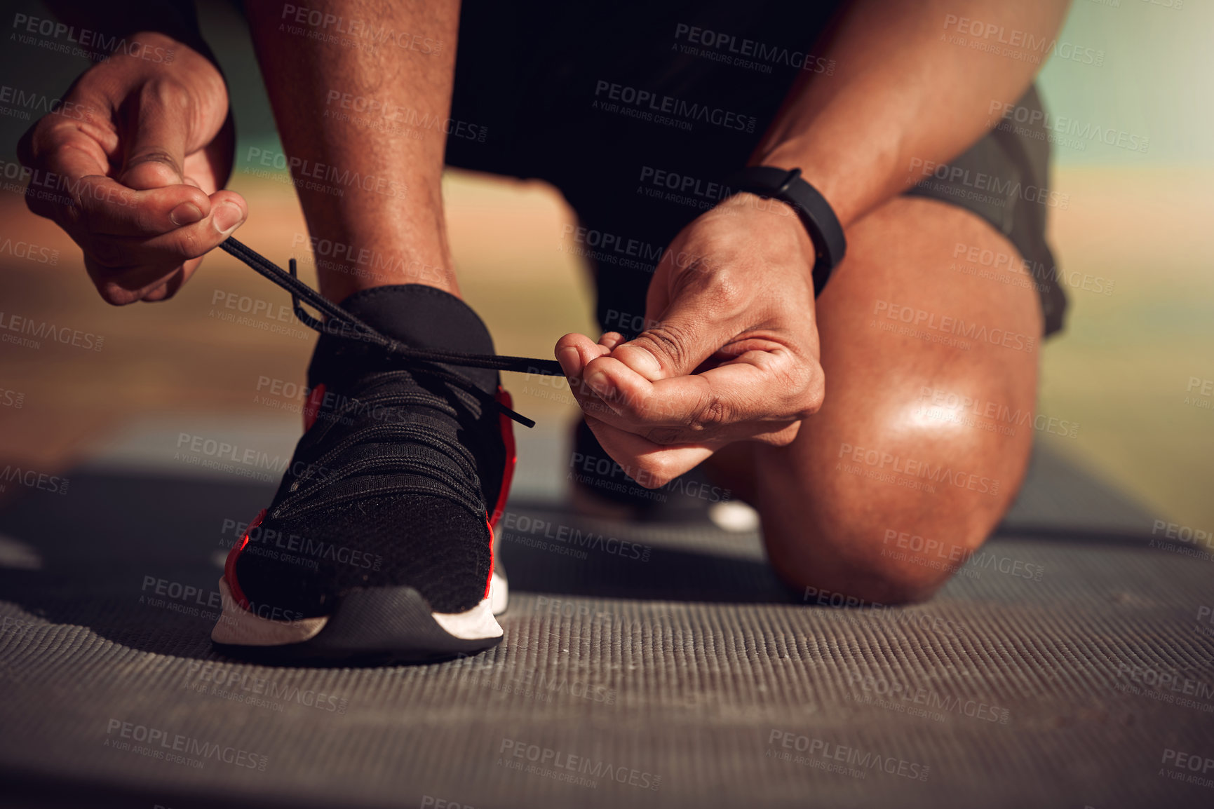 Buy stock photo Shot of a man tying his laces before running