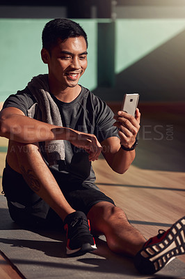 Buy stock photo Gym, phone and happy man on floor on video call, fitness and happiness with media, exercise and chat. Internet, cellphone and workout, healthy male athlete on mat in pilates or yoga studio with smile