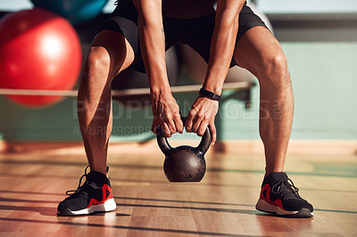 Buy stock photo Kettlebell, fitness and hands of person for workout, exercise and development for sport. Bodybuilder, metal and legs of athlete with performance at gym for wellness, training and healthy progress