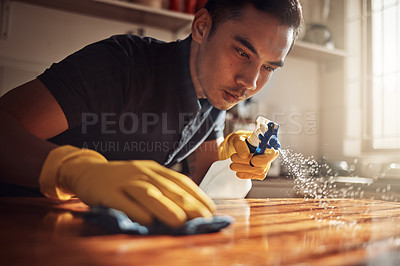 Buy stock photo Home, cleaning and man with disinfectant for kitchen counter, housekeeping and chore. Person, cleaner and guy with spray bottle, cloth and routine with spring cleaning, remove dust and bacteria