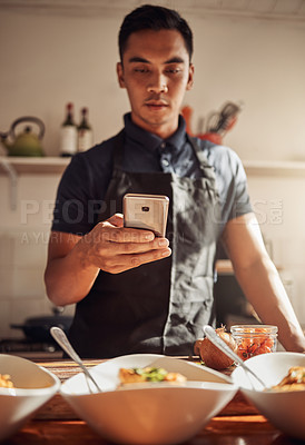 Buy stock photo Person, man and smartphone with food or meal, kitchen and culinary art for cooking in apartment. Healthy, nutrition and lunch servings on counter, gourmet and picture for social media post or blog