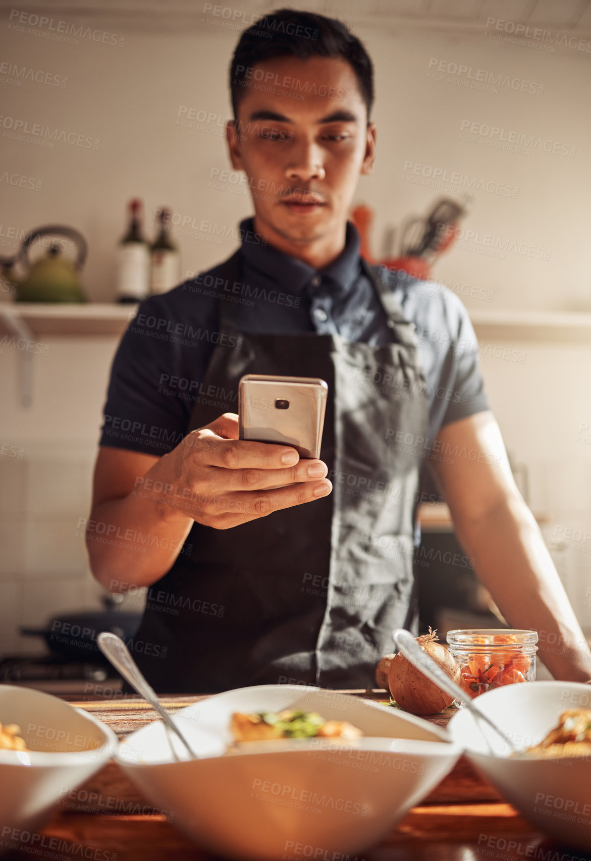 Buy stock photo Person, man and smartphone with food or meal, kitchen and culinary art for cooking in apartment. Healthy, nutrition and lunch servings on counter, gourmet and picture for social media post or blog