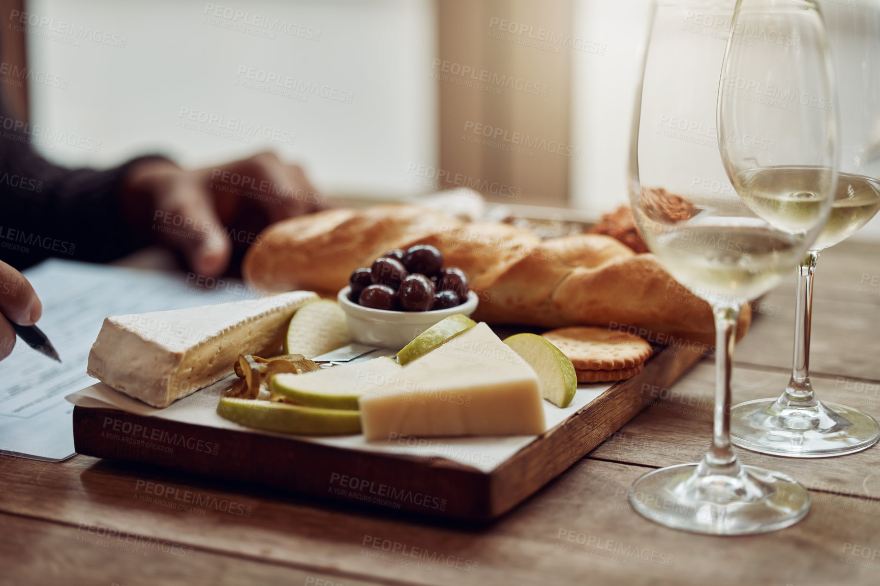 Buy stock photo Shot of a man enjoying a cheese platter and tasting different wines