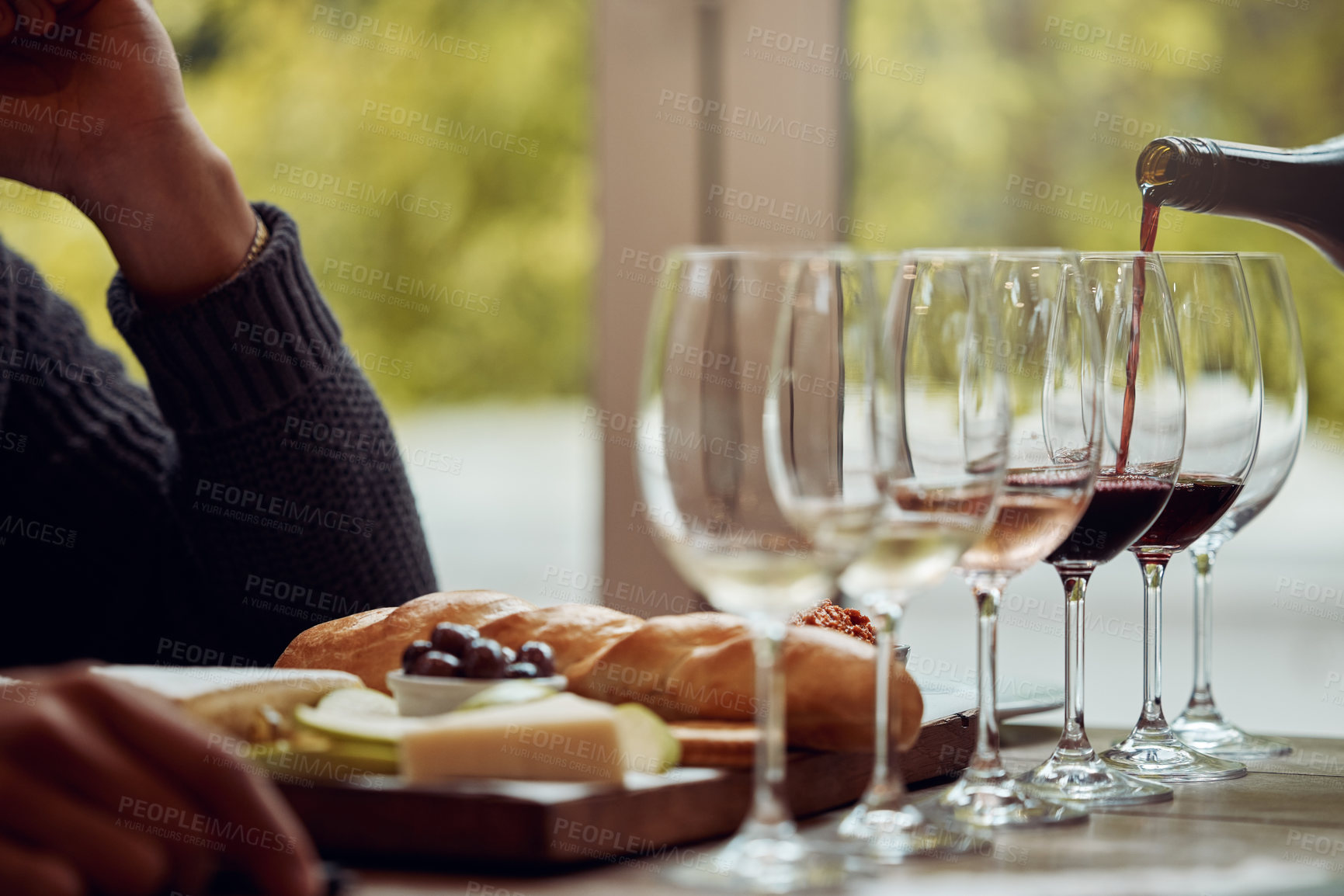 Buy stock photo Shot of a man enjoying a cheese platter and tasting different wines