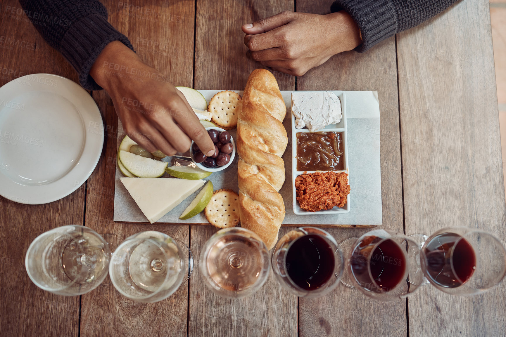 Buy stock photo Shot of a man enjoying a cheese platter and tasting different wines