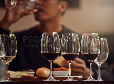 Buy stock photo Shot of a man enjoying a cheese platter and tasting different wines