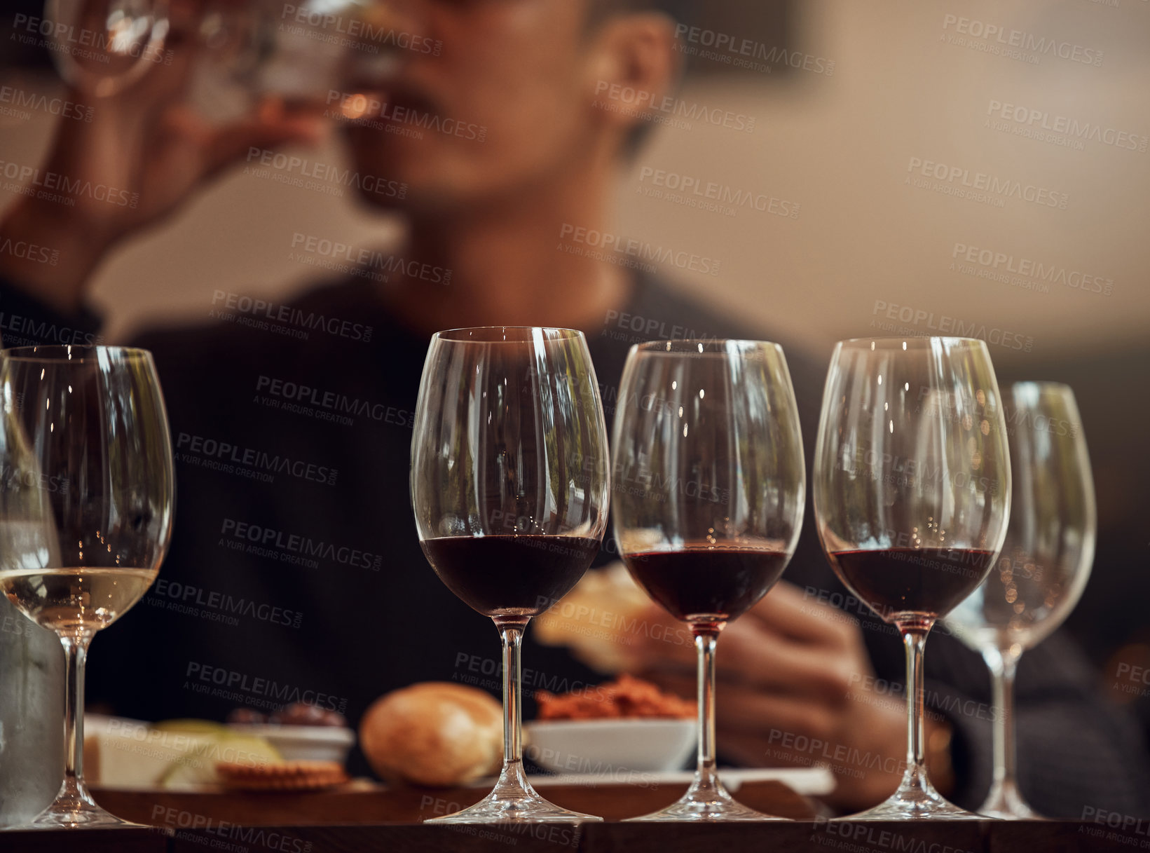 Buy stock photo Shot of a man enjoying a cheese platter and tasting different wines