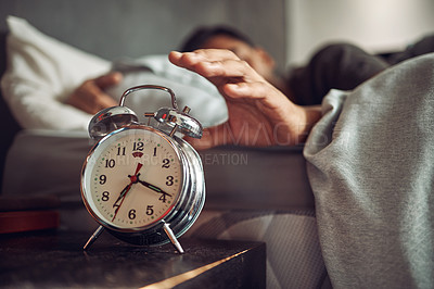 Buy stock photo Alarm clock, wake up and man sleeping in the bedroom of his modern apartment in the morning. Lazy, resting and hand of male person taking a nap and dreaming in bed with time watch at his home.