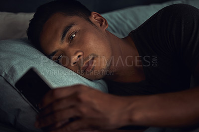 Buy stock photo Dark, browse and man in bed with phone surfing internet, social media post or texting with insomnia in home. Wake up, scroll and male in bedroom with cellphone, mobile game and digital app at night.