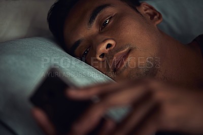 Buy stock photo Night, bed and face of man with phone addiction, internet or social media, texting with insomnia in home. Wake up, online chat and male in dark bedroom with cellphone, mobile game and digital app.