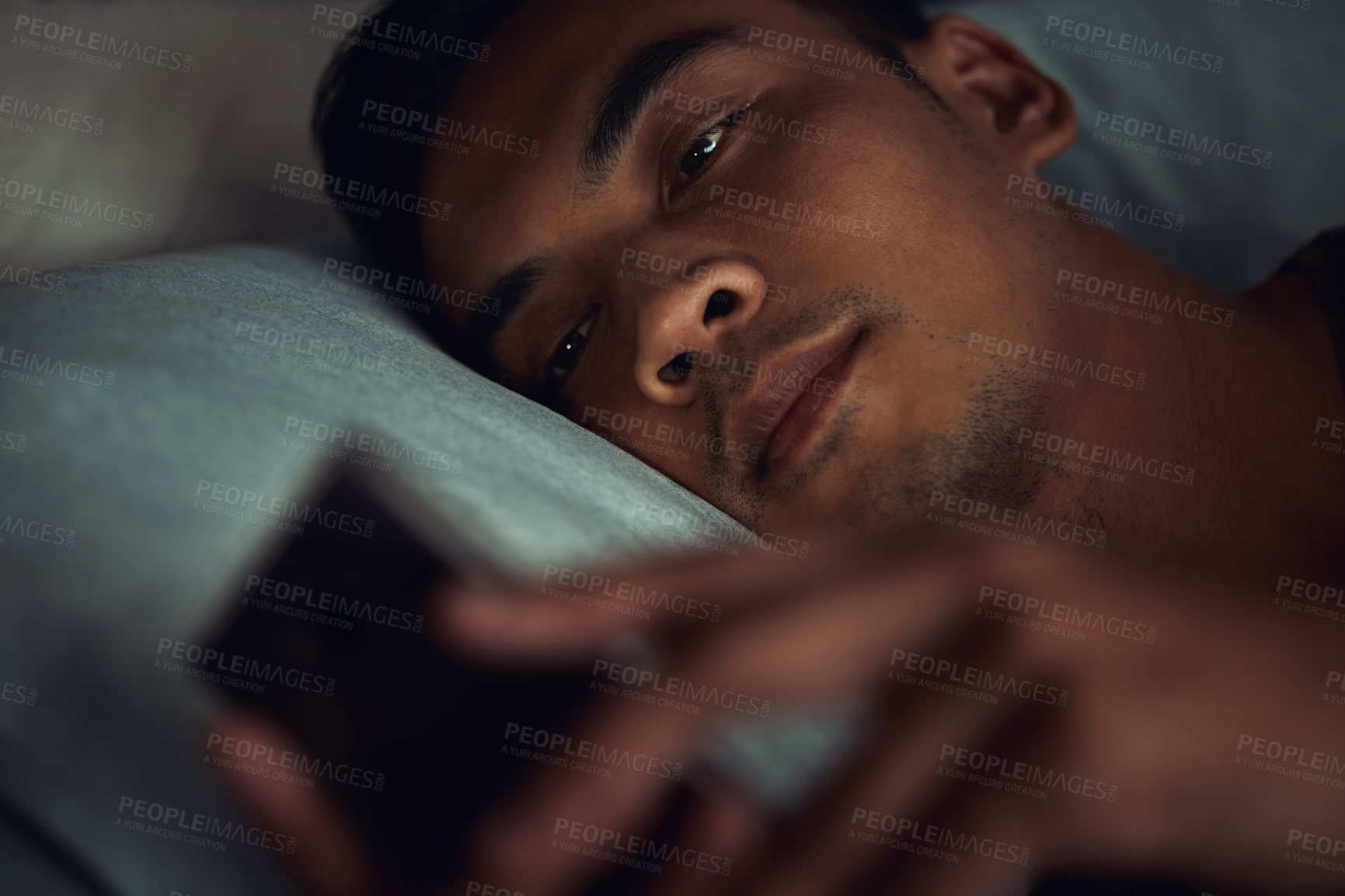 Buy stock photo Night, bed and face of man with phone addiction, internet or social media, texting with insomnia in home. Wake up, online chat and male in dark bedroom with cellphone, mobile game and digital app.