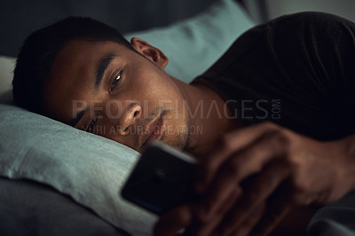 Buy stock photo Night, bed and tired man with phone, internet scroll and social media post or texting, insomnia in home. Wake up, browse and exhausted male in dark bedroom with cellphone, mobile game or digital app.