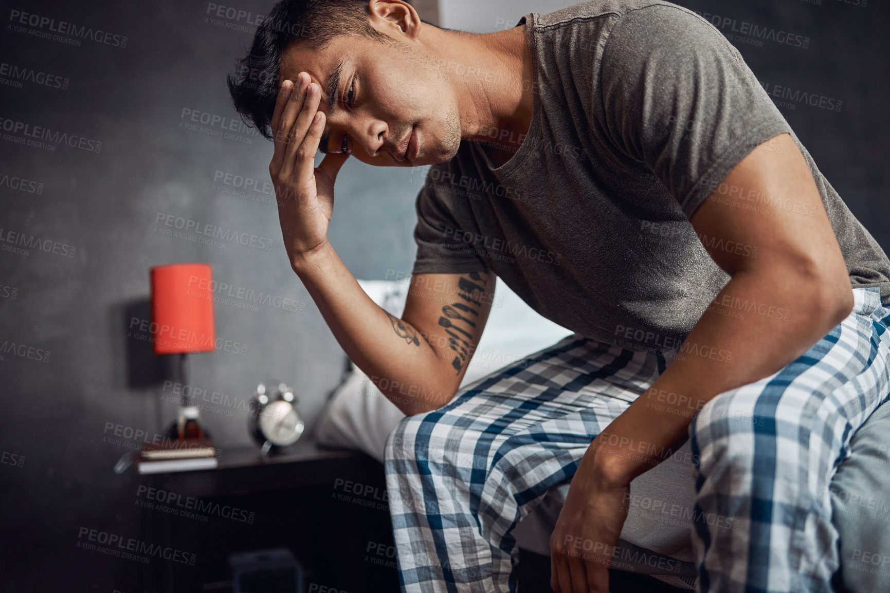 Buy stock photo Shot of a young man feeling unwell in bed at home