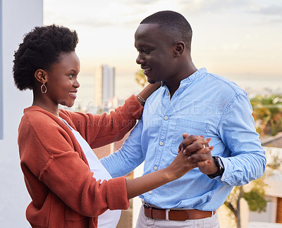 Buy stock photo Couple, happy and dancing on balcony outside for bonding, romance and intimate moment. Smile, African people and holding hands for trust, love and support in pregnancy for marriage and celebration 