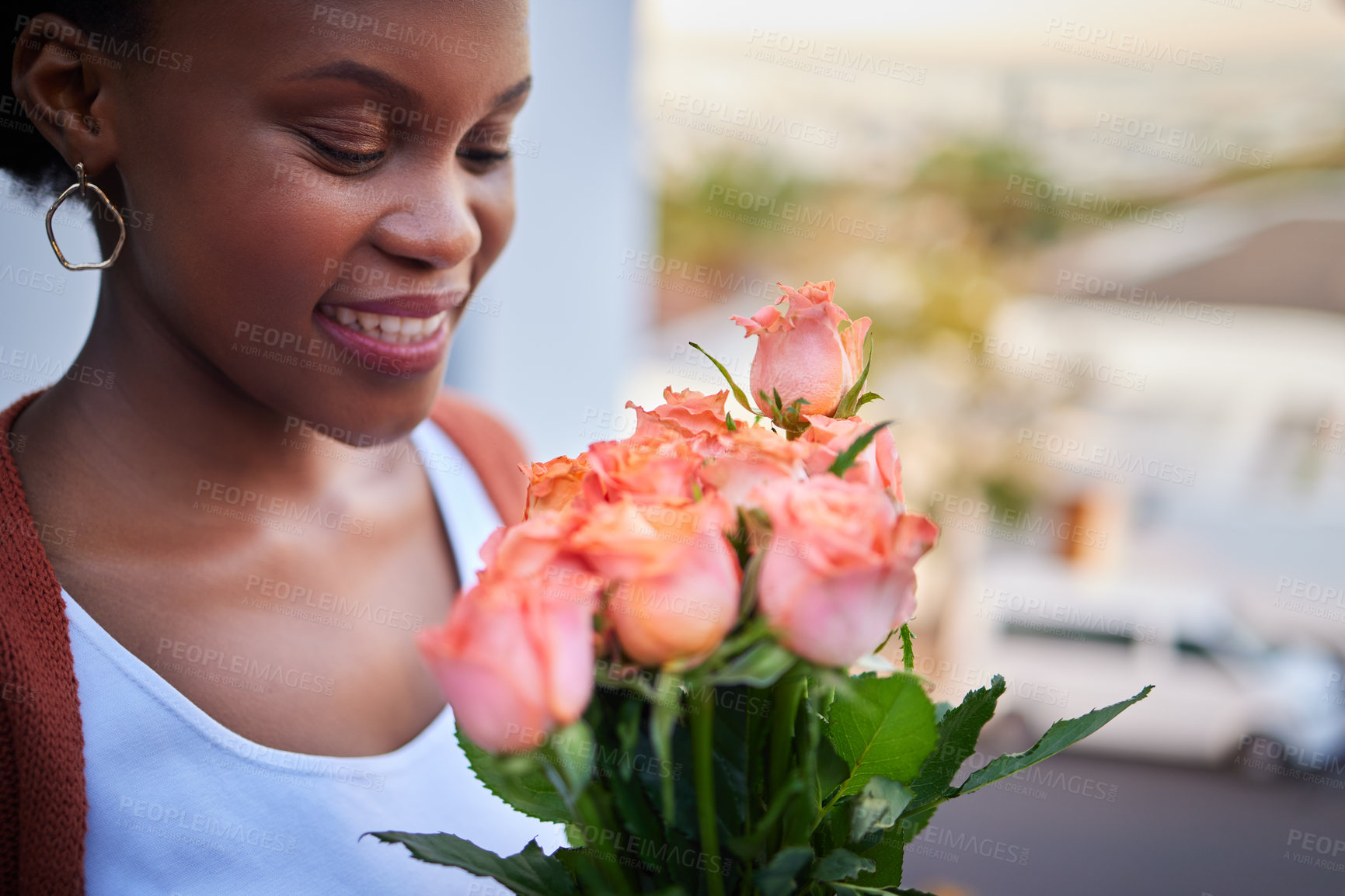 Buy stock photo Black woman, flowers or happy for relationship or anniversary in city, gift for birthday on balcony. Female person, home or roses with smile in outdoor or commitment, surprise with bouquet for dating