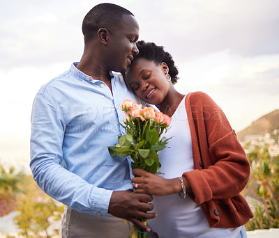 Buy stock photo Pregnant, wife and couple with man and flowers, outside and bonding for relationship. Husband, romantic and giving gift for romance with expecting woman, happy and family development with hug