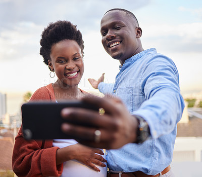 Buy stock photo Black couple, selfie and outdoor on balcony, happy and show city in profile picture on social media. Man, pregnant woman and smile with live streaming with travel vlogging on vacation with memory