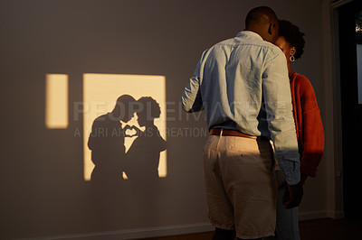 Buy stock photo Shot of an unrecognizable couple standing together and sharing an intimate moment at home