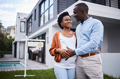 Buy stock photo Portrait of a young couple standing outside their new home