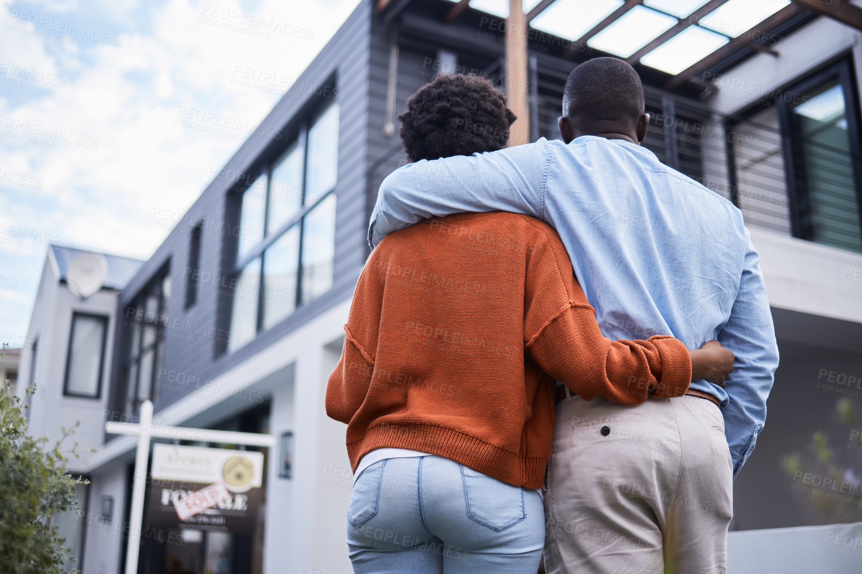 Buy stock photo Love, hugging and back of couple by their new home, property or real estate standing together. Relocation, romance and behind of an African man and woman homeowners embracing by their modern house.