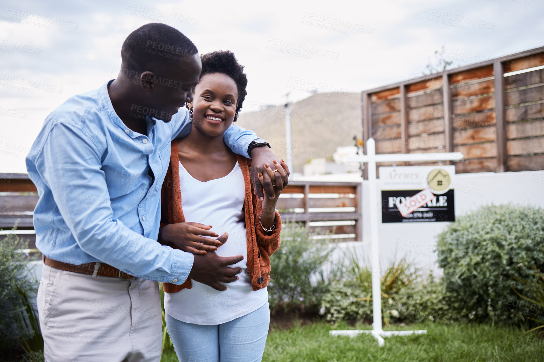 Buy stock photo Outdoor, smile and black couple with new home, hug and achievement with mortgage loan approval, real estate and excited. Happiness, man and woman with embrace, pregnant or investment with property